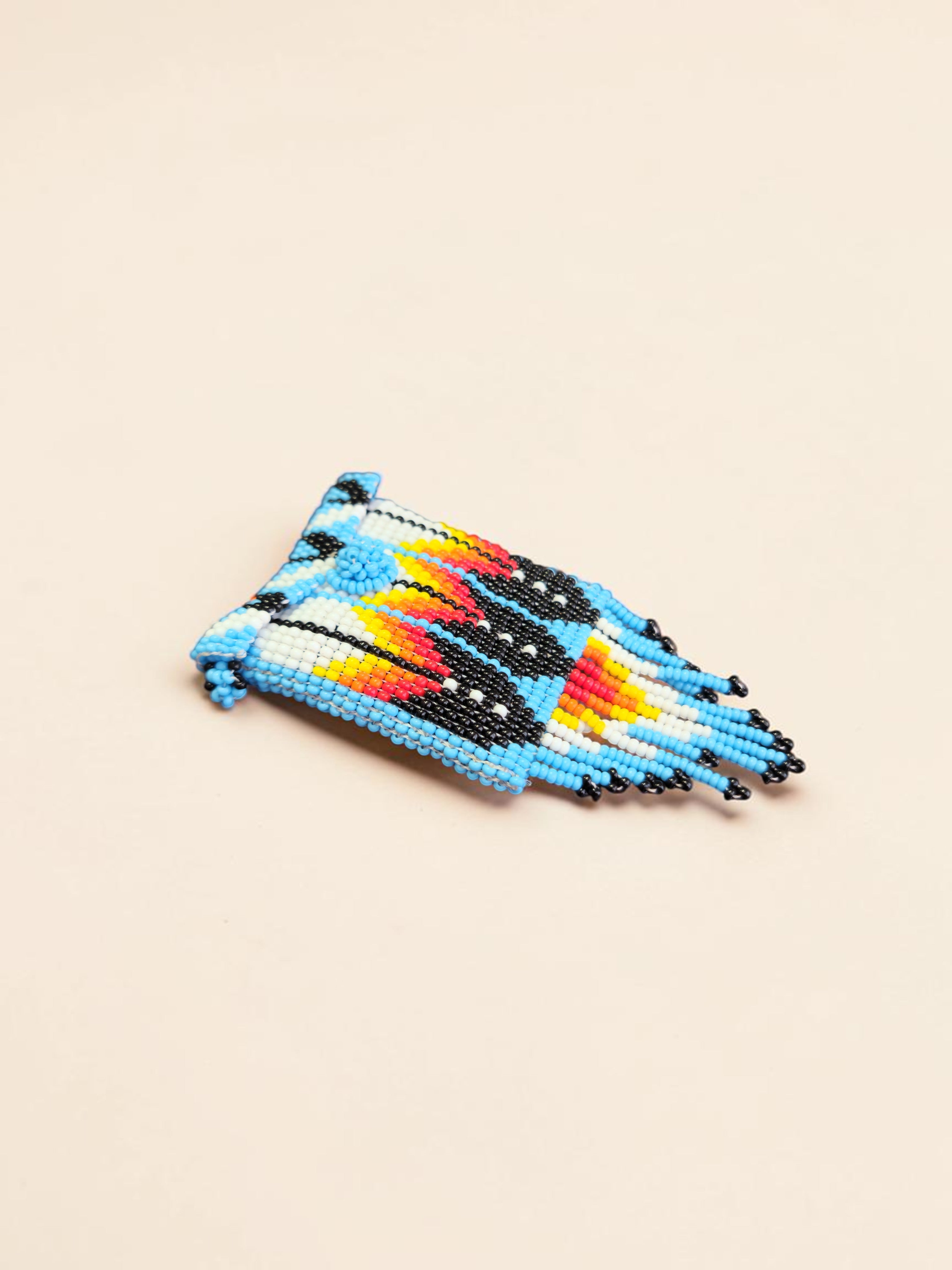 Colorful beaded phone case on a beige background