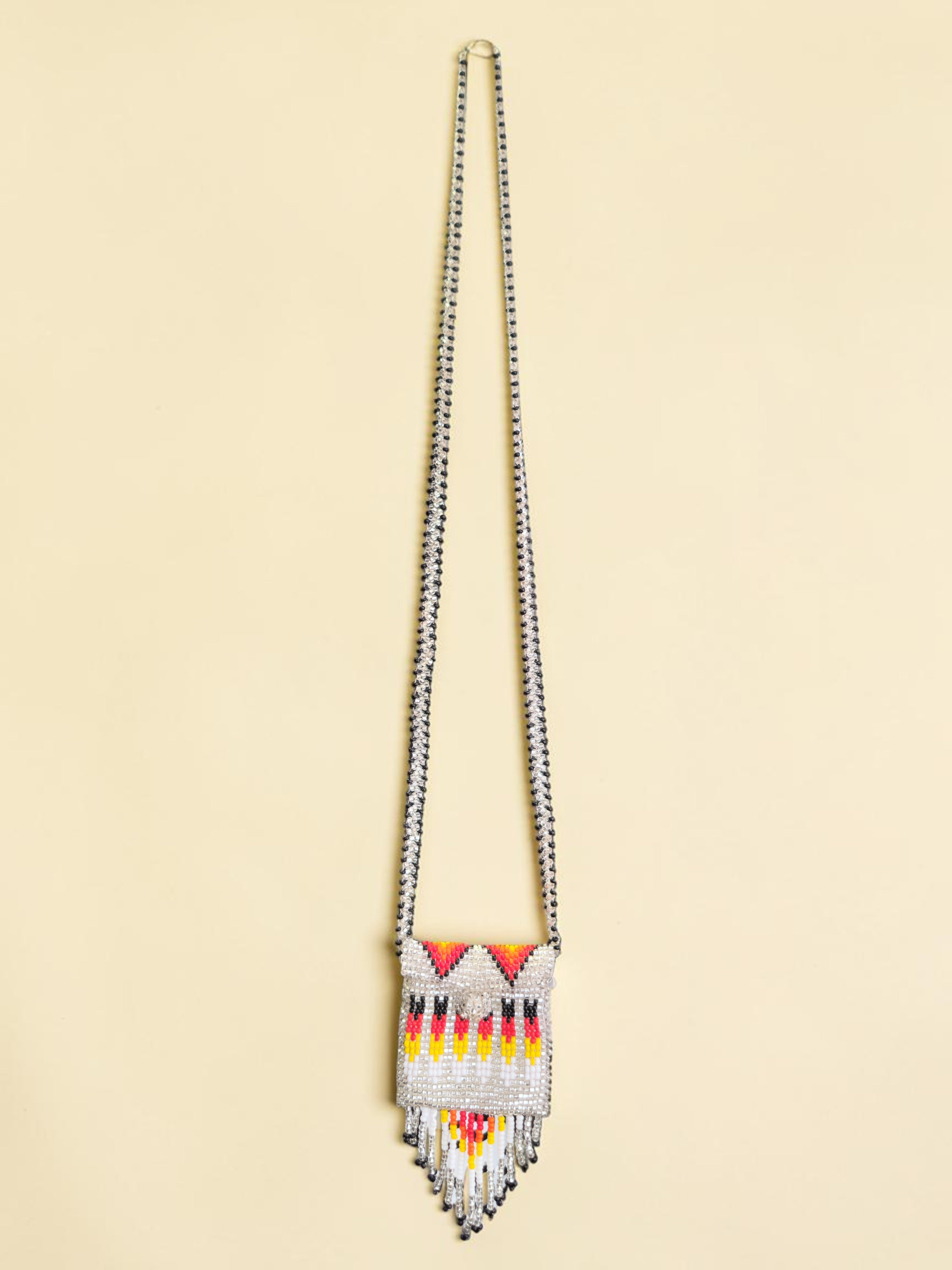 Beaded necklace with a colorful pendant on a beige background