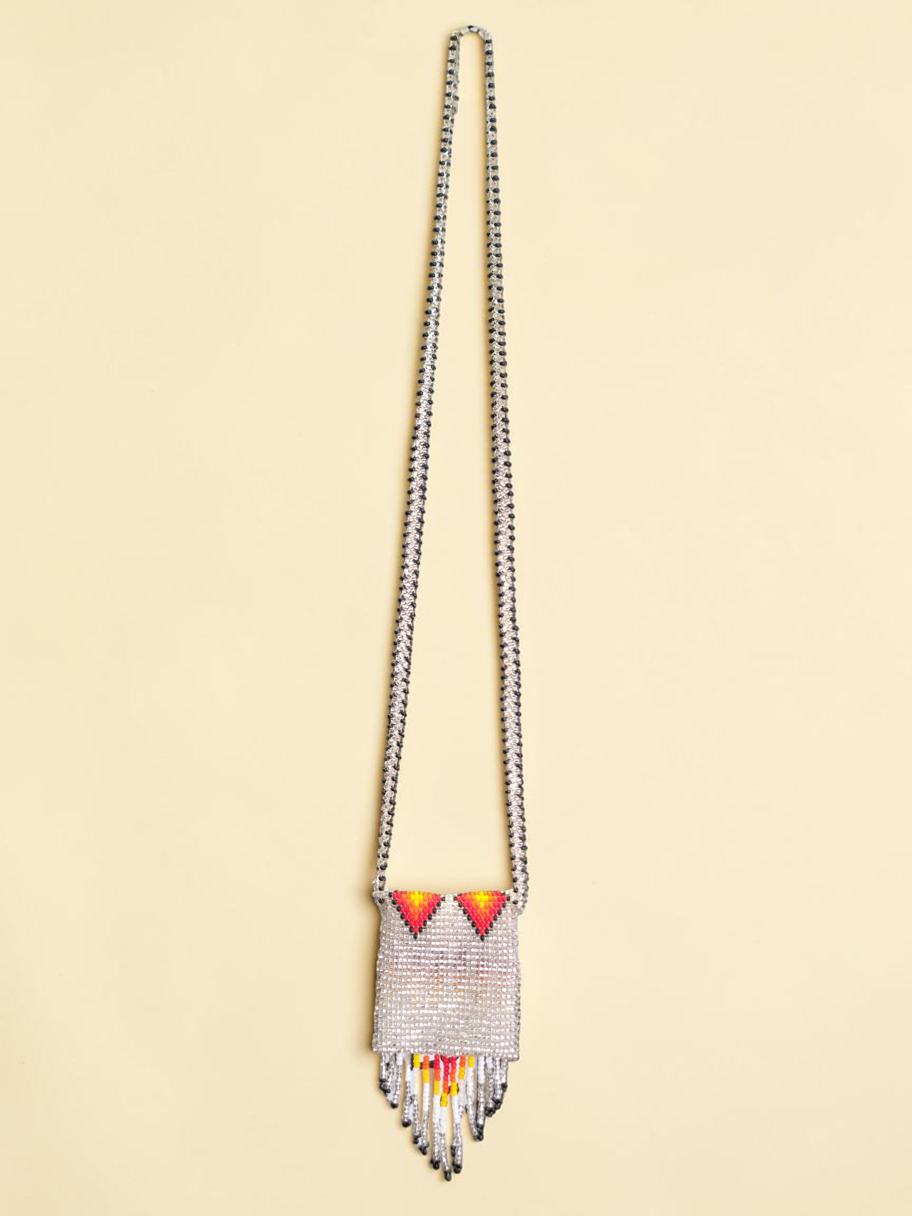 Beaded necklace with colorful accents on a beige background