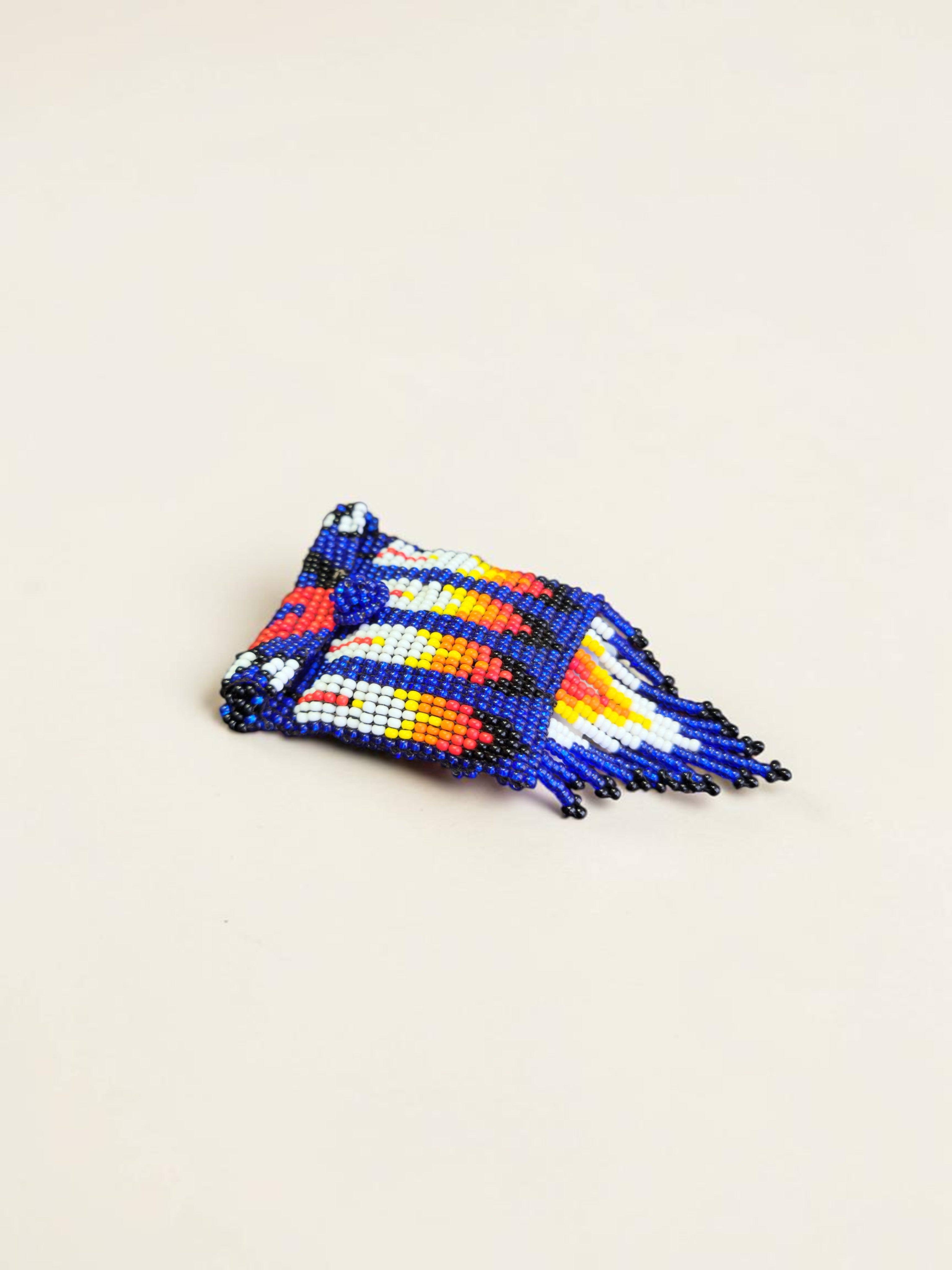 Colorful beaded clutch on a light beige background