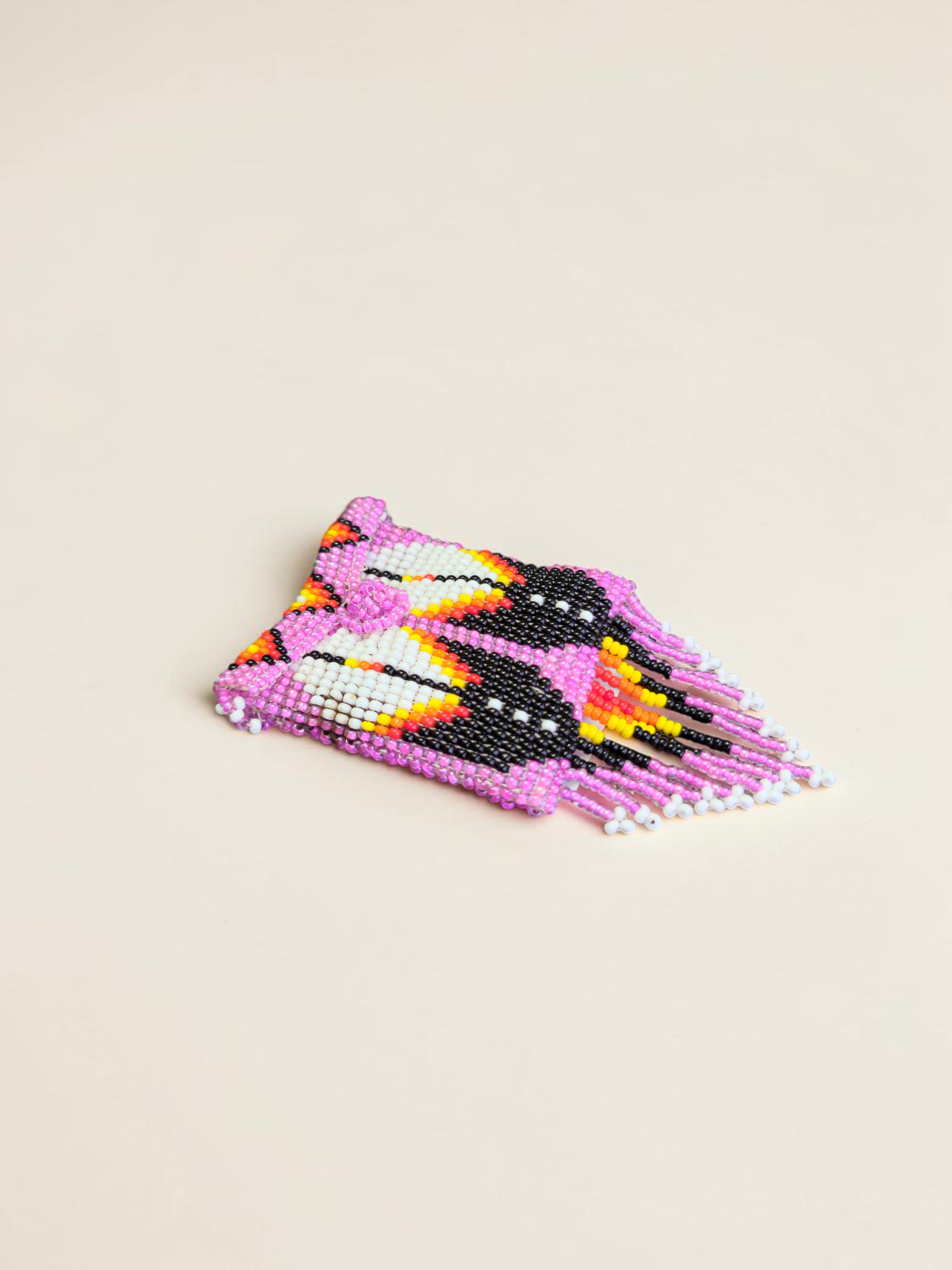 Colorful beaded hair clip on a beige background