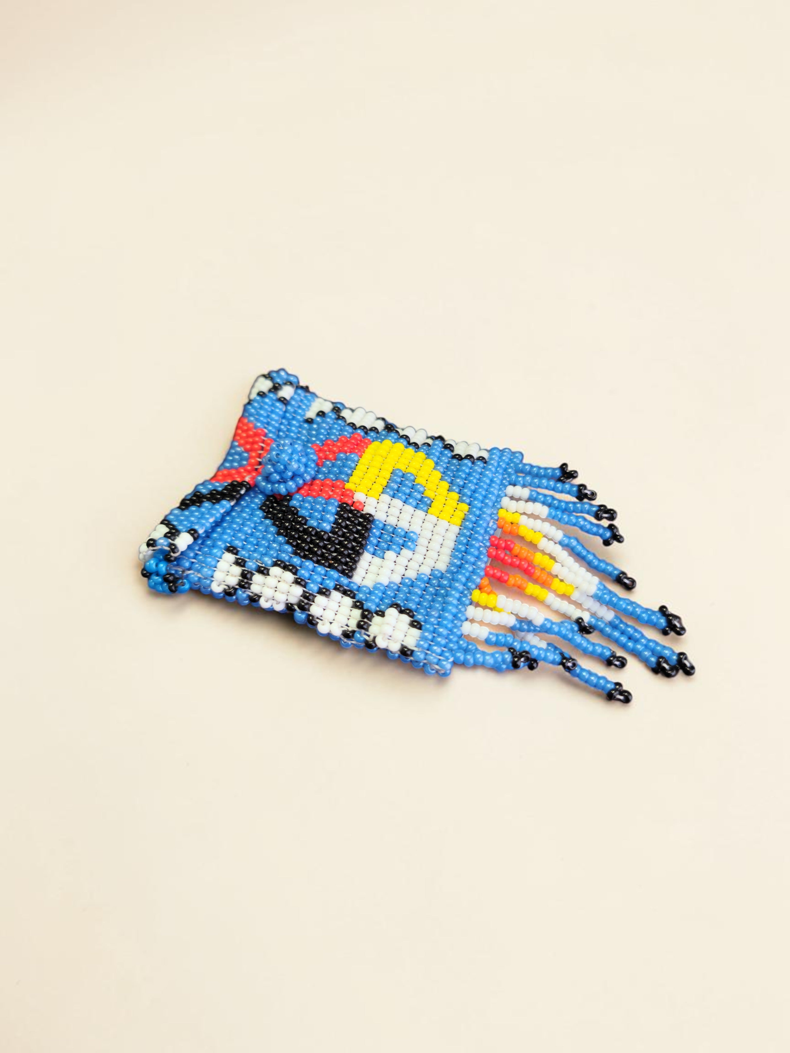 Beaded clutch with colorful design on a beige background