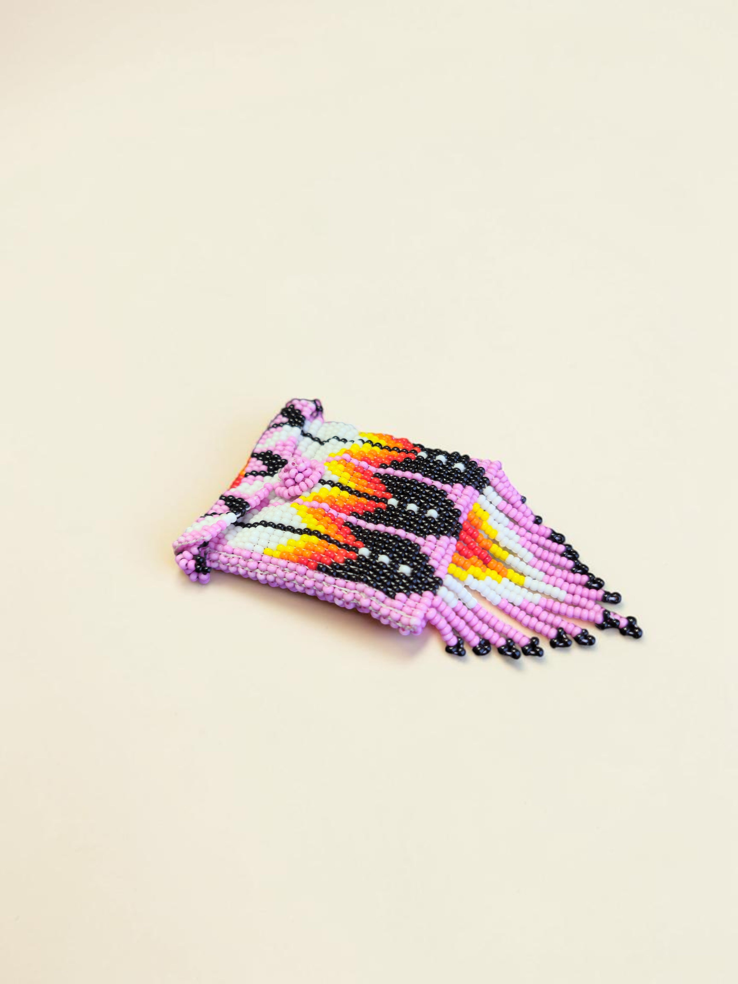 Colorful beaded pouch on a beige background