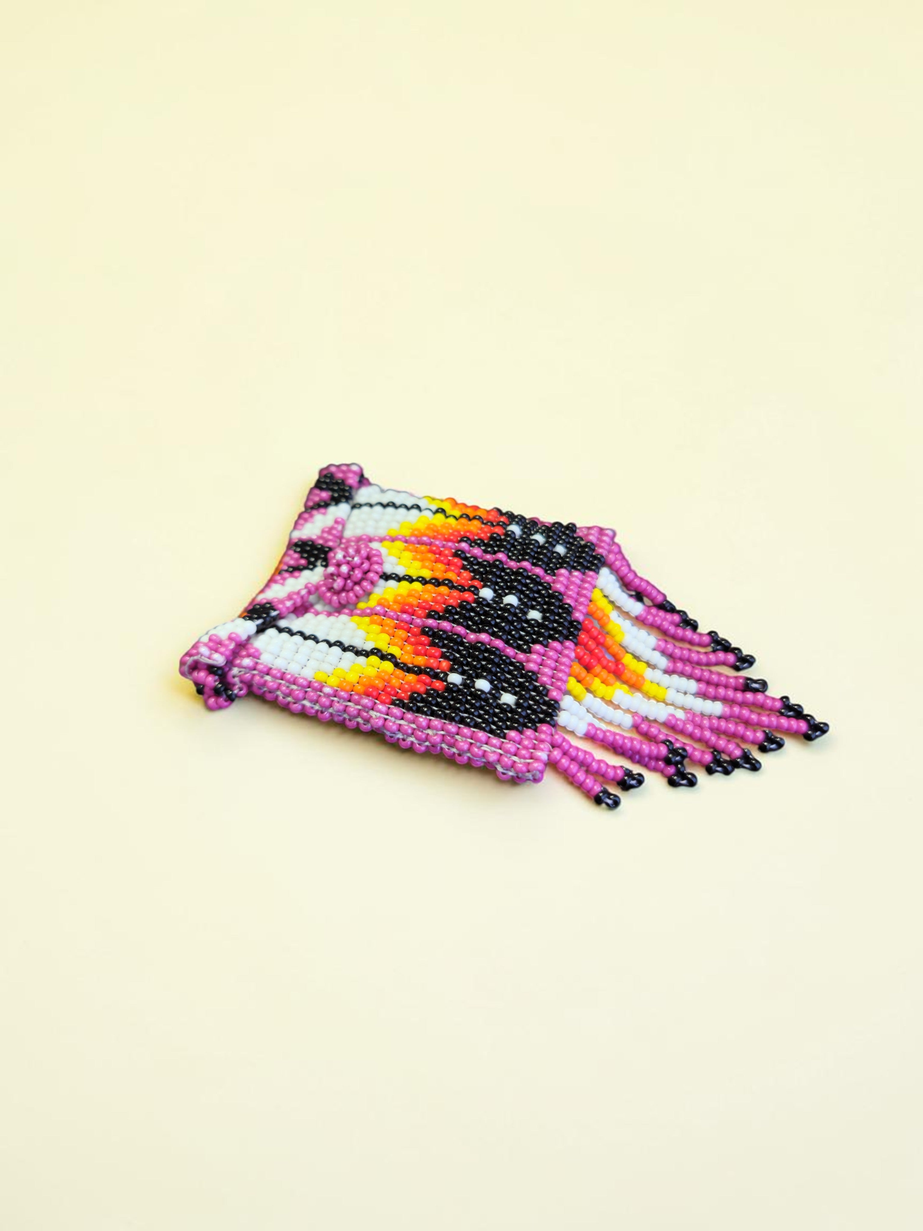 Set of colorful beaded bracelets on a beige background