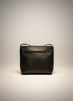 Black leather handbag on a light gray background