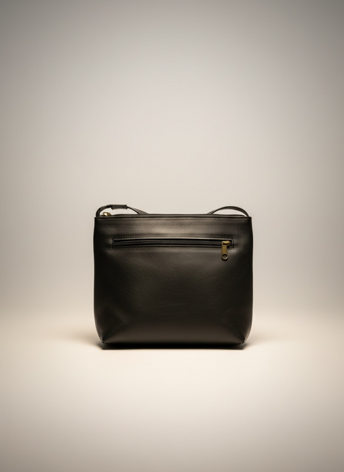 Black leather handbag on a light gray background