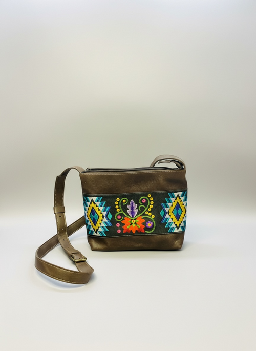 Brown leather handbag with colorful embroidery on a white background