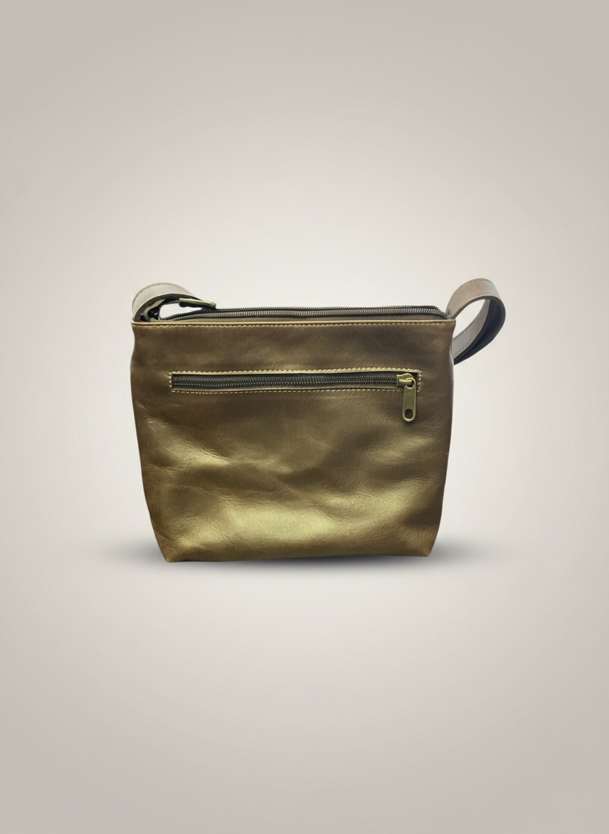 Gold leather crossbody bag on a light gray background