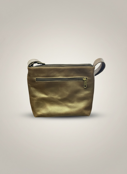 Gold leather crossbody bag on a light gray background